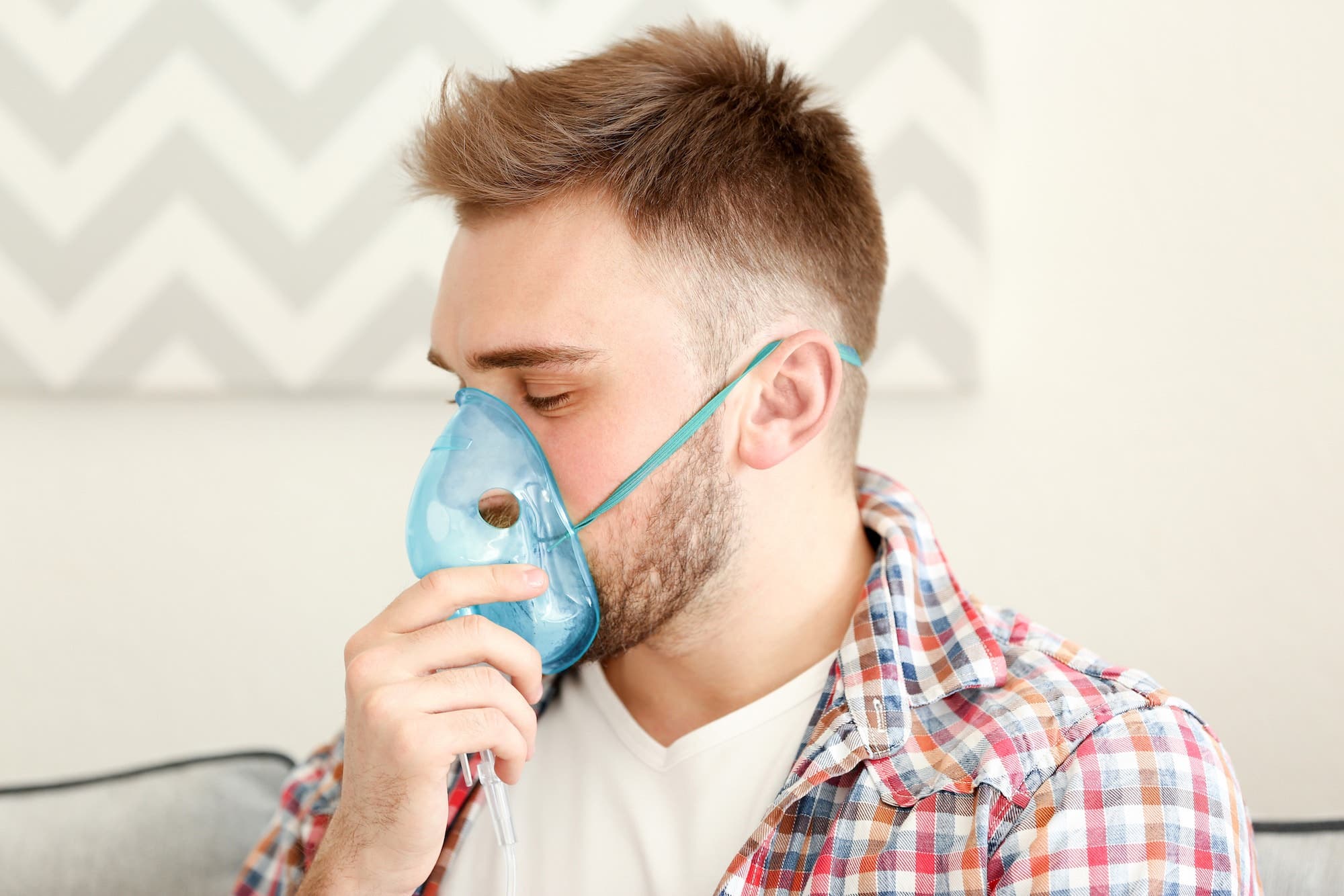 Man using a nebulizer to treat cystic fibrosis