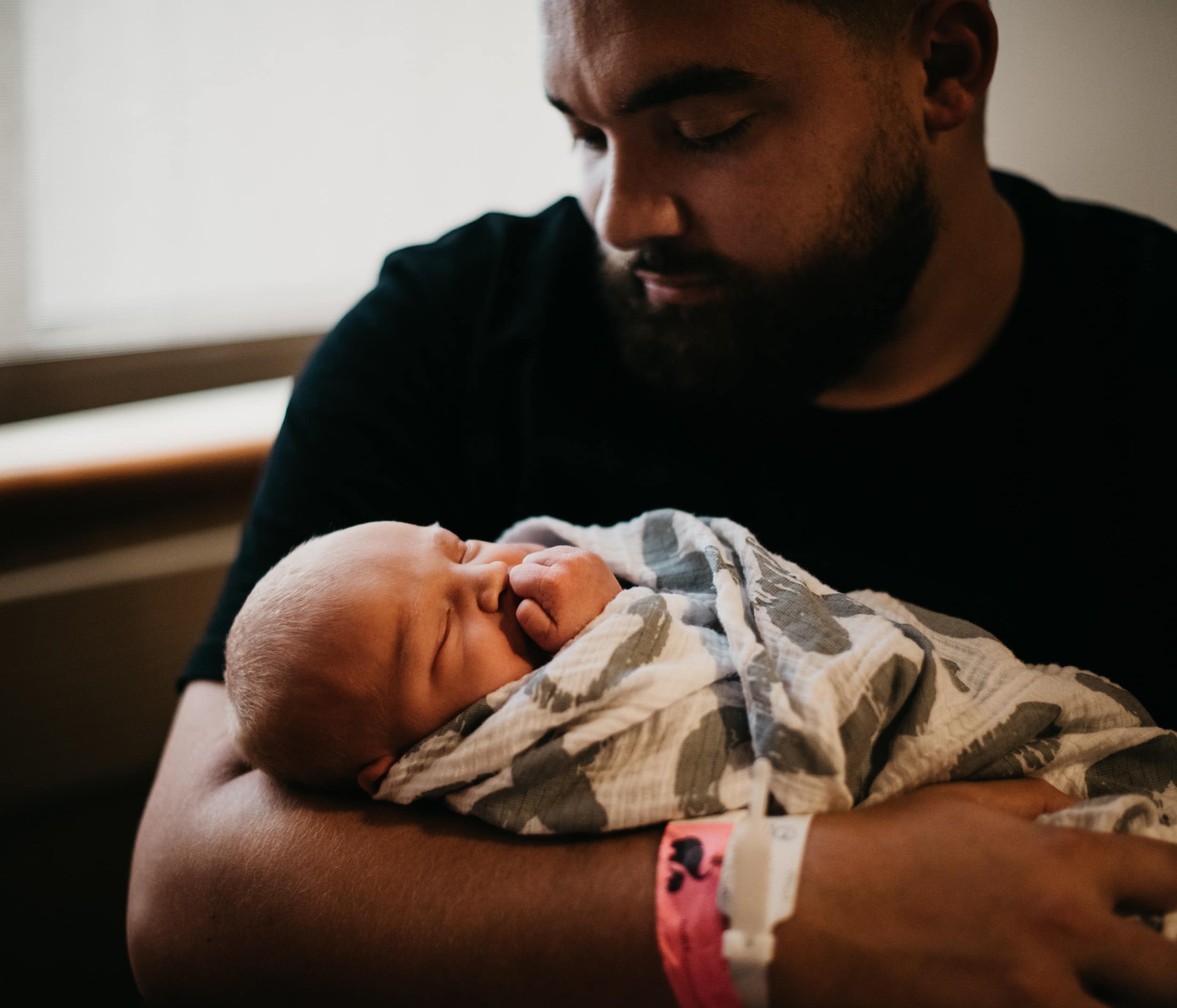 Man holding newborn baby