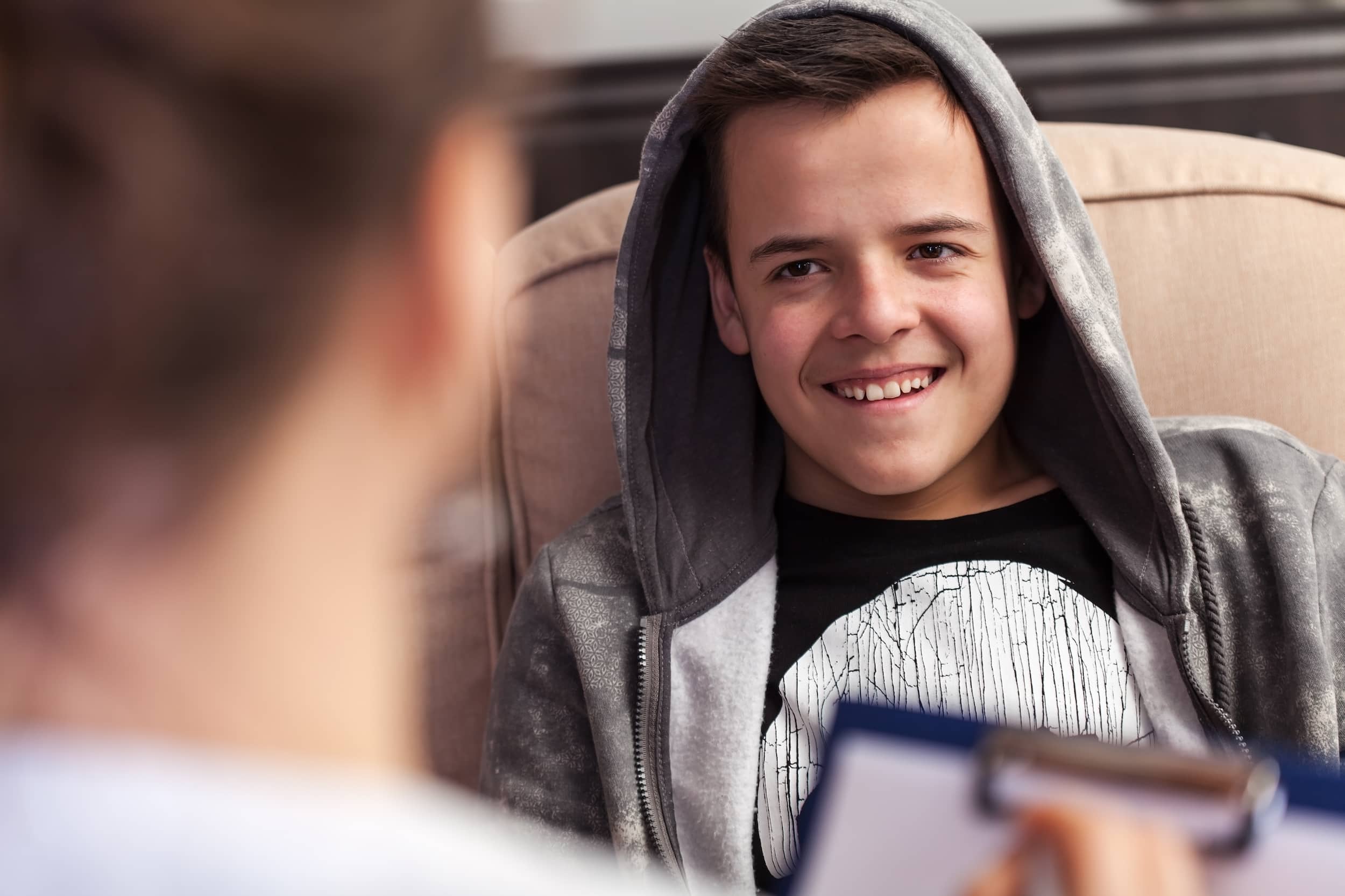 Teen boy at the doctor receiving a diagnosis for Kallmann syndrome