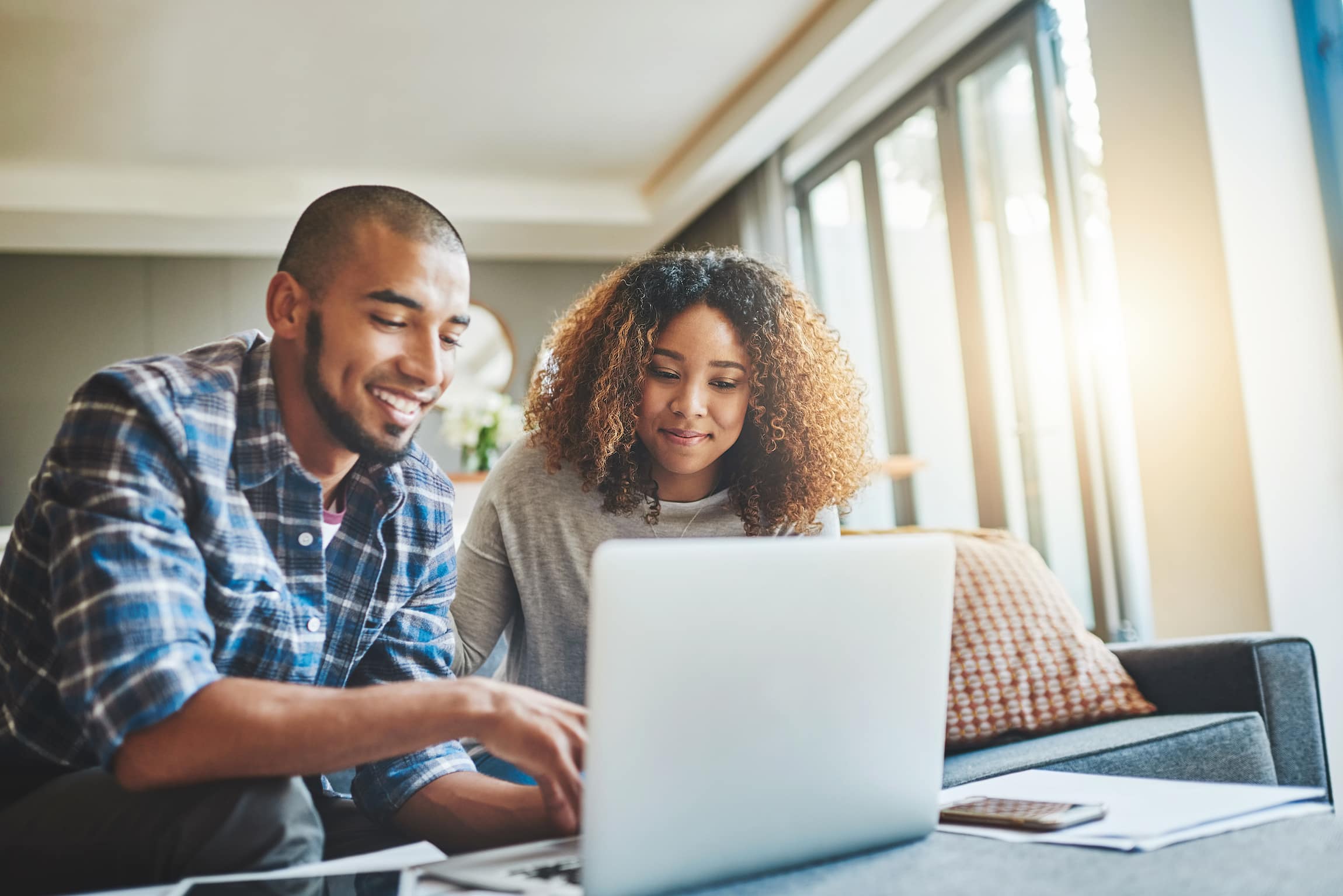 Shot of a young couple using a laptop to plan for trying to conceive