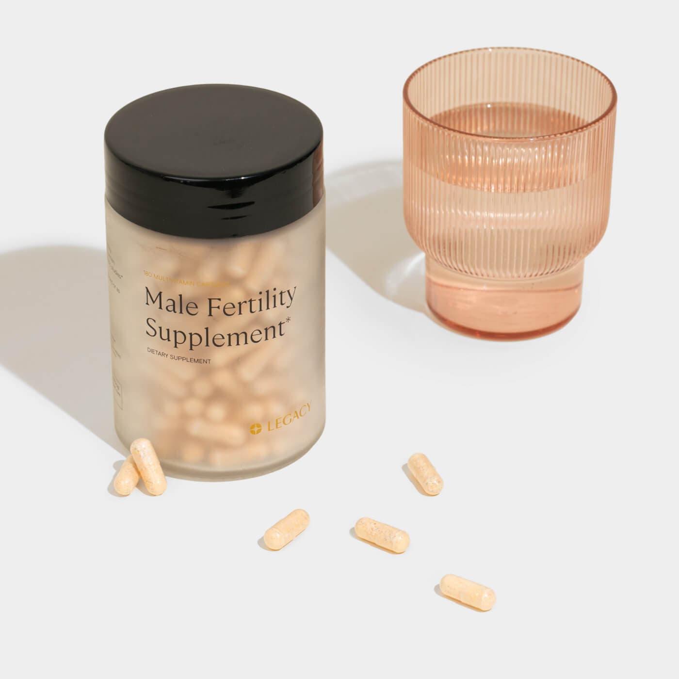 Male fertility supplements bottle with glass